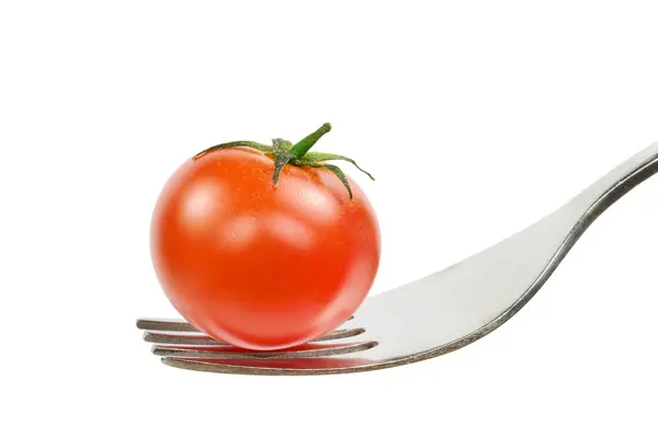 A fresh tomato on a fork — Stockfoto