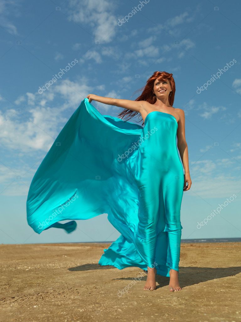 Happy woman desert beach wind blowing dress — Stock Photo © shotsstudio ...