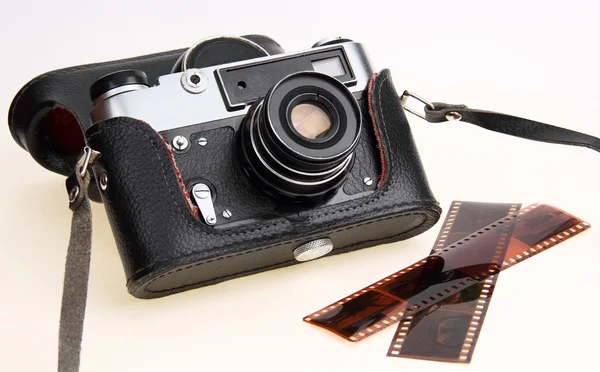 Retro camera in black case. Negative film — Stock Photo, Image