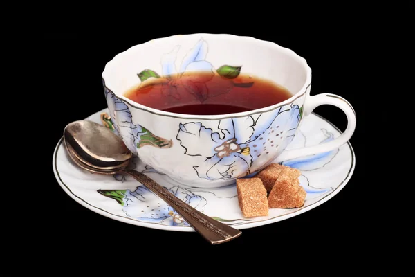 Tea in a white cup. Saucer with sugar and a spoon — Stock Photo, Image