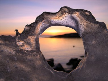 Sunset through ice's hole clipart