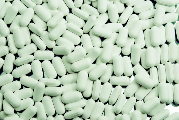Grüner Hintergrund der Tabletten — Stockfoto