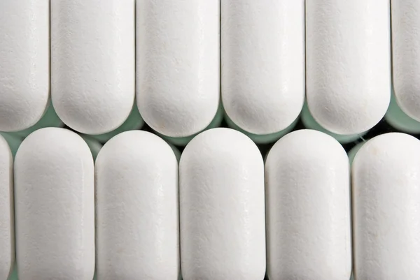 Sfondo di pillole bianche primo piano — Foto Stock