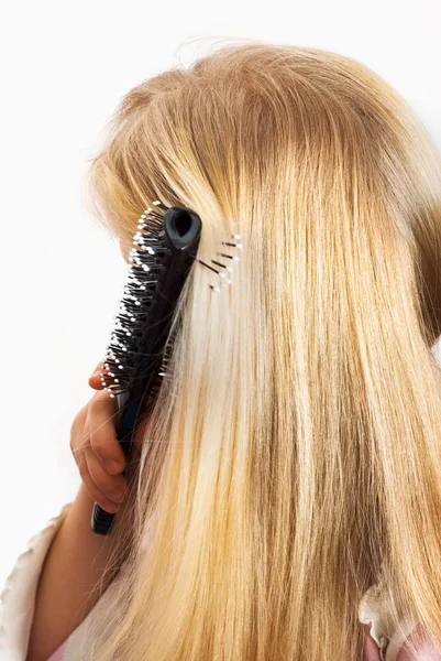 stock image Little girl combing her hair