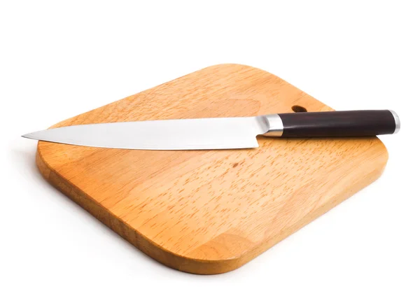 Kitchen knife lying on a cutting board — Stock Photo, Image