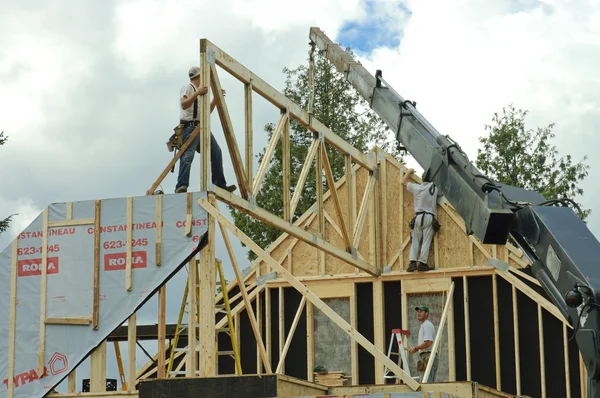 stock image Roof framing with worker and crane