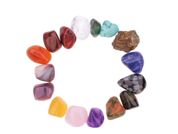Цветовой спектр полудрагоценных камней в окружной рамке, на whi — стоковое фото