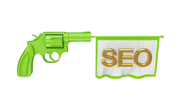 Зеленый револьвер и белый флаг с золотым словом SEO . — стоковое фото