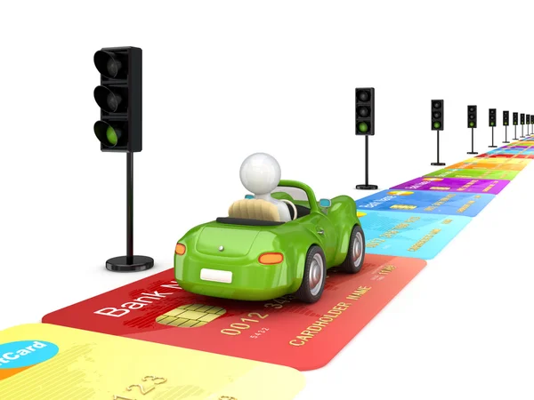 stock image Green car driving on a road made of credit cards.