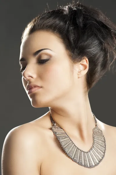 The girl with silver necklace, she looks at right Stock Image