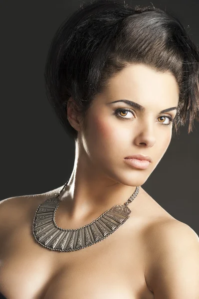 The girl with silver necklace, turned of three quarters Stock Picture