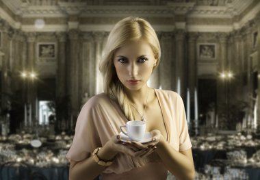 Blond sensual woman with a coffee cup clipart