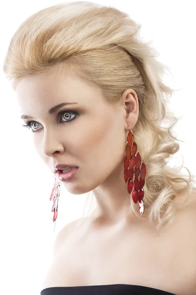 Red earring on cute blond girl, with an axpression of surprise Royalty Free Stock Images