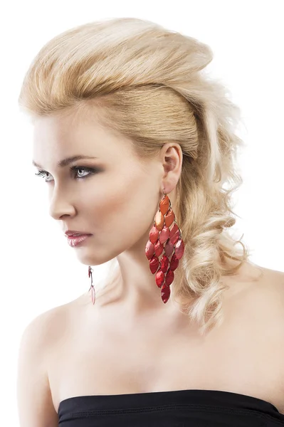 Red earring on cute blond girl, she is turned of three quarters Stock Image