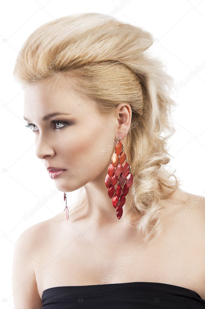 Red earring on cute blond girl, she is turned of three quarters