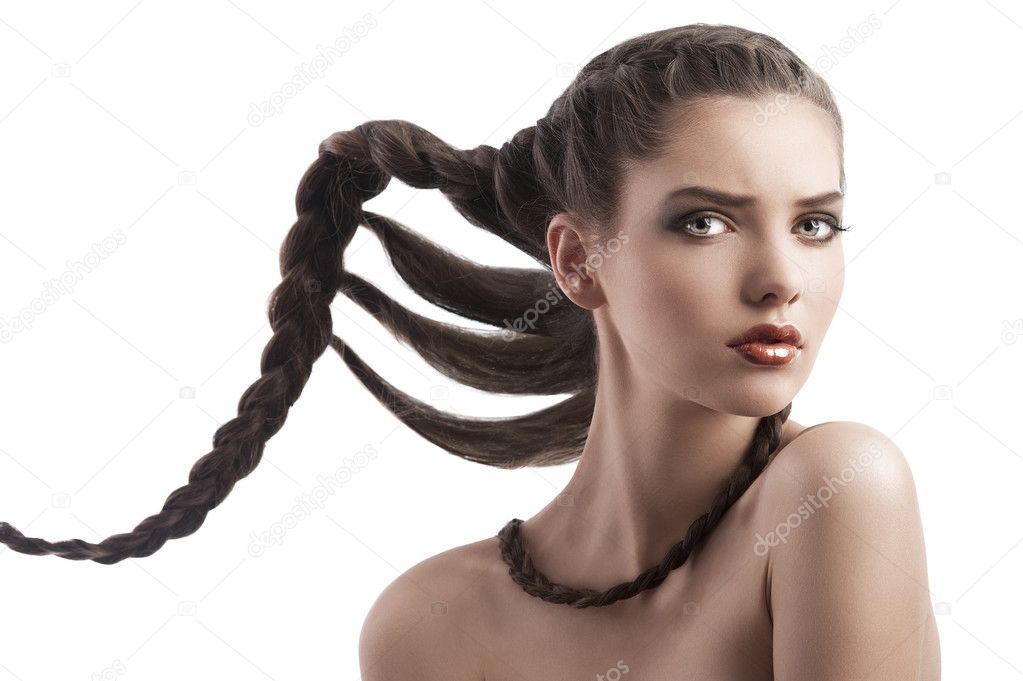 Beauty face shot of a brunette with a creative hairstyle