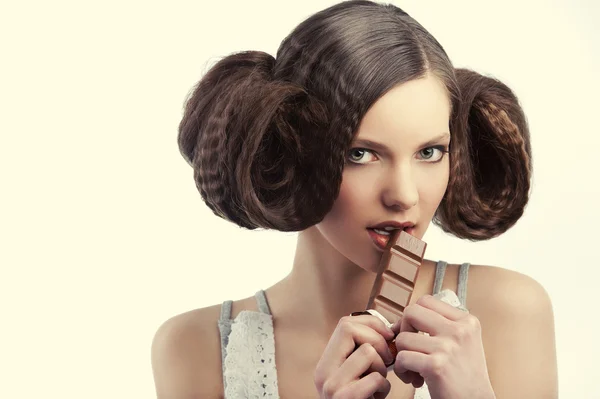 Vintage style girl eating chocolate — Stock Photo, Image