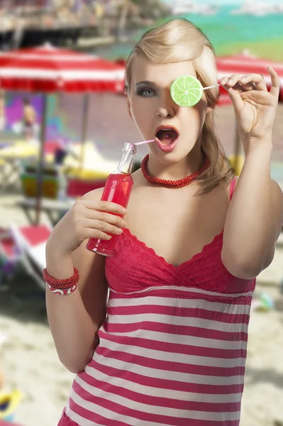 Fashion summer girl drinking, she covers her left eye with lolli — Stock Photo, Image