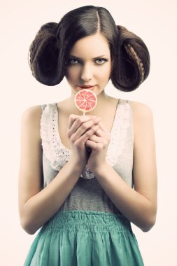 Vintage girl with lollipop, she looks at right, she has a sly ex clipart