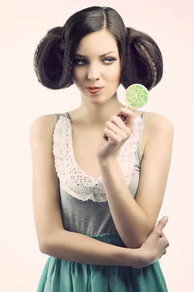 Vintage girl with lollipop, she looks the lollipop — Stock Photo, Image