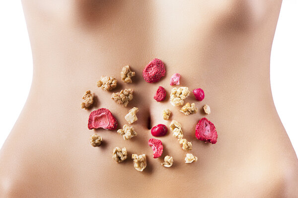 Composition of cereals and red dried fruits over belly