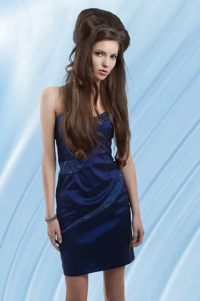 Brunette in short blue dress — Stok fotoğraf