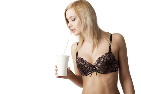 Drinking girl in lingerie she looks in to the cup — Stock Photo, Image