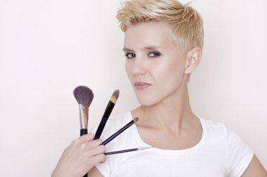 Make-up artist holding brushes clipart