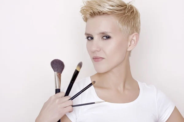 Make-up artist holding brushes — Stock Photo, Image
