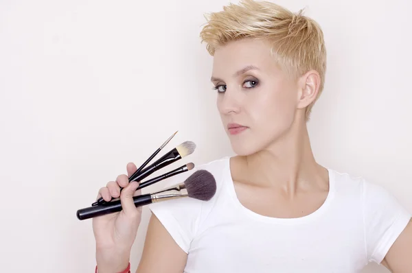 Make-up artist holding brushes — Stock Photo, Image