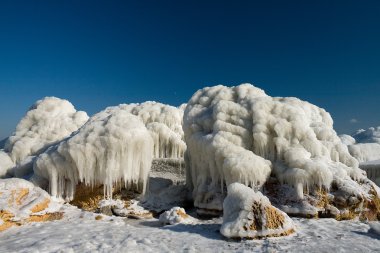 The ice-encrusted rock.