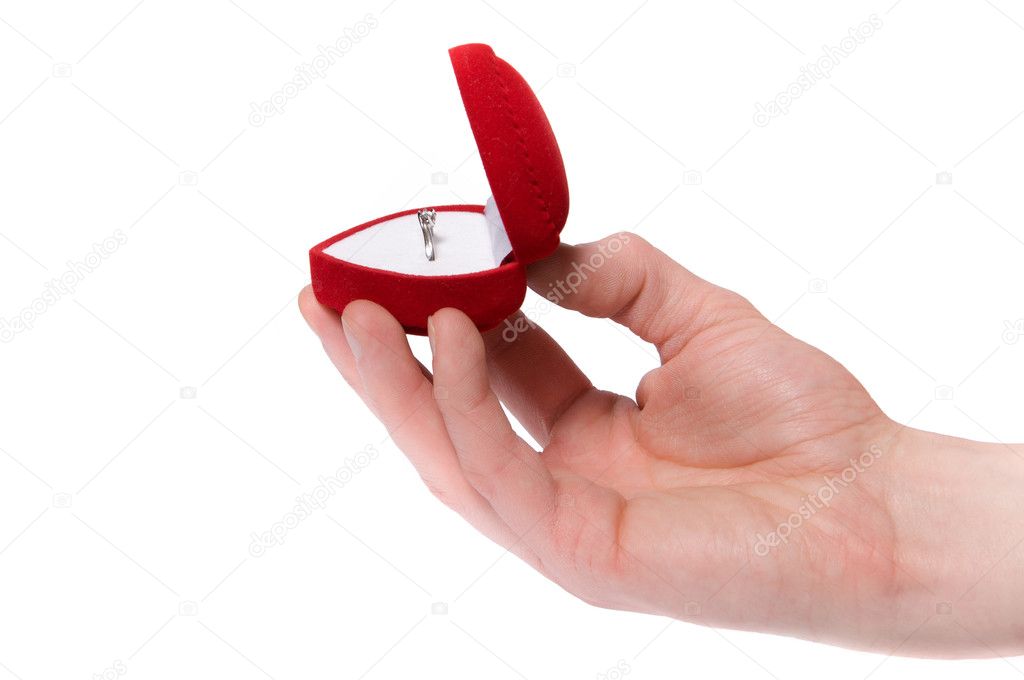 Man's hand holding engagement ring isolated