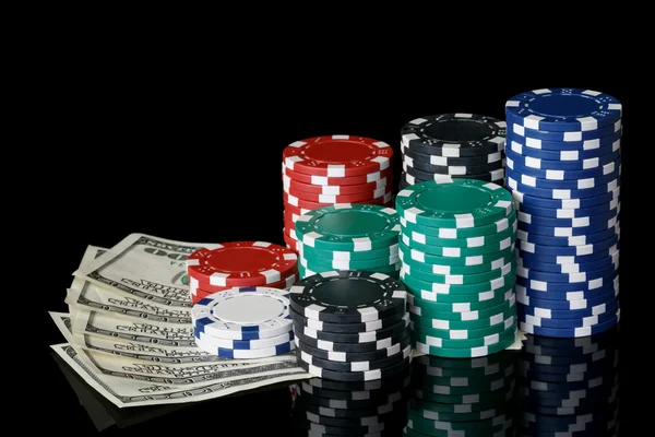 Stacks of poker chips with money — Stock Photo, Image