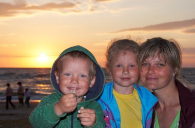 Family on evening beach clipart