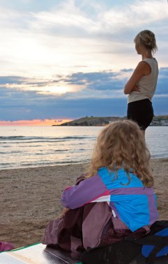 Girl on evening beach clipart