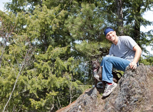 stock image Man and his dog on a rock