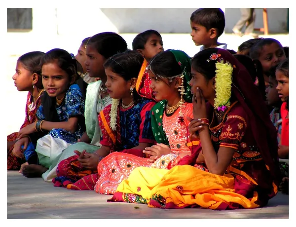 Nice girl from India watching performances of students in school, — Stock Photo, Image