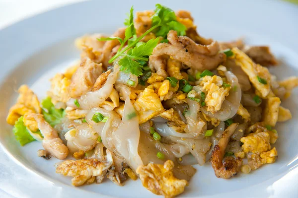 Stir fried noodles with egg, pork, green vetgetables, and sweet soy bean sa — Stock Photo, Image
