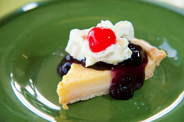 Blueberry cheesecake with cream and red jelly : delicious sweet and dessert — Stock Photo, Image