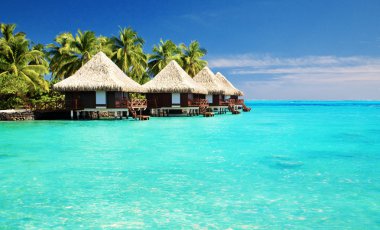 Over water bungalows with steps into amazing lagoon clipart