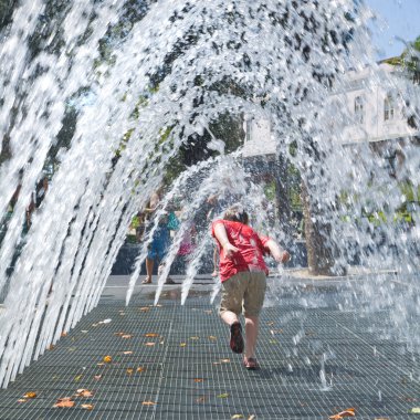 Little boy running under an arch fountain clipart