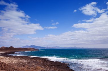 View towards Lanzarote, Canary islands from small island Isla de clipart