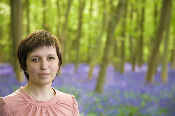 Young woman in bluebell forest — Stock Photo, Image