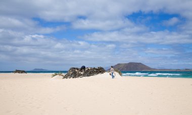 Canary Islands, Fuertevemtura - father and son getting into volcanic stone 