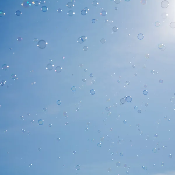 Bubbles on pale blue sky background