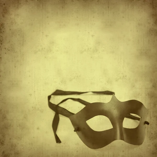 Texturizado fundo de papel velho com meia máscara de carnaval — Fotografia de Stock