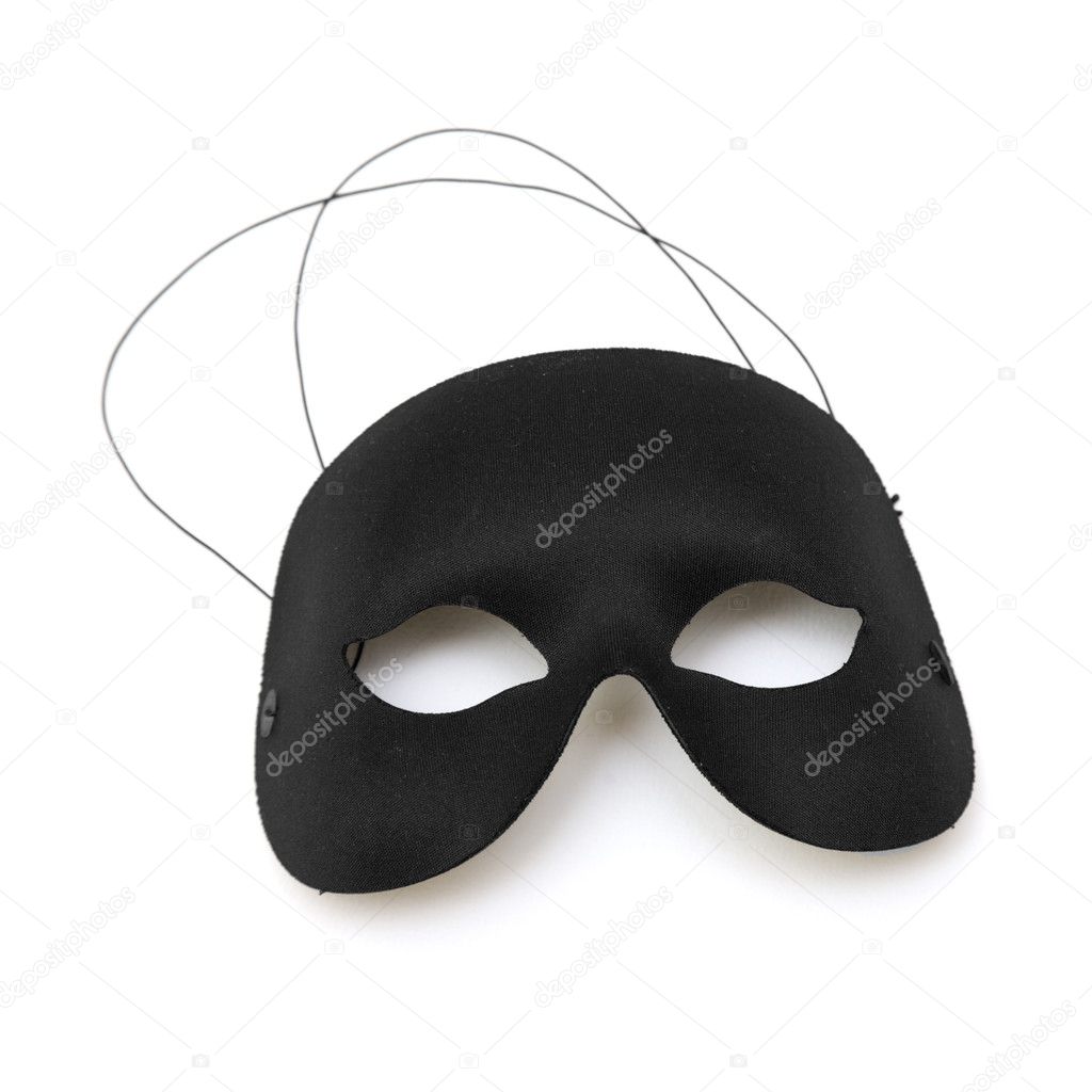 Black half-mask on white surface;