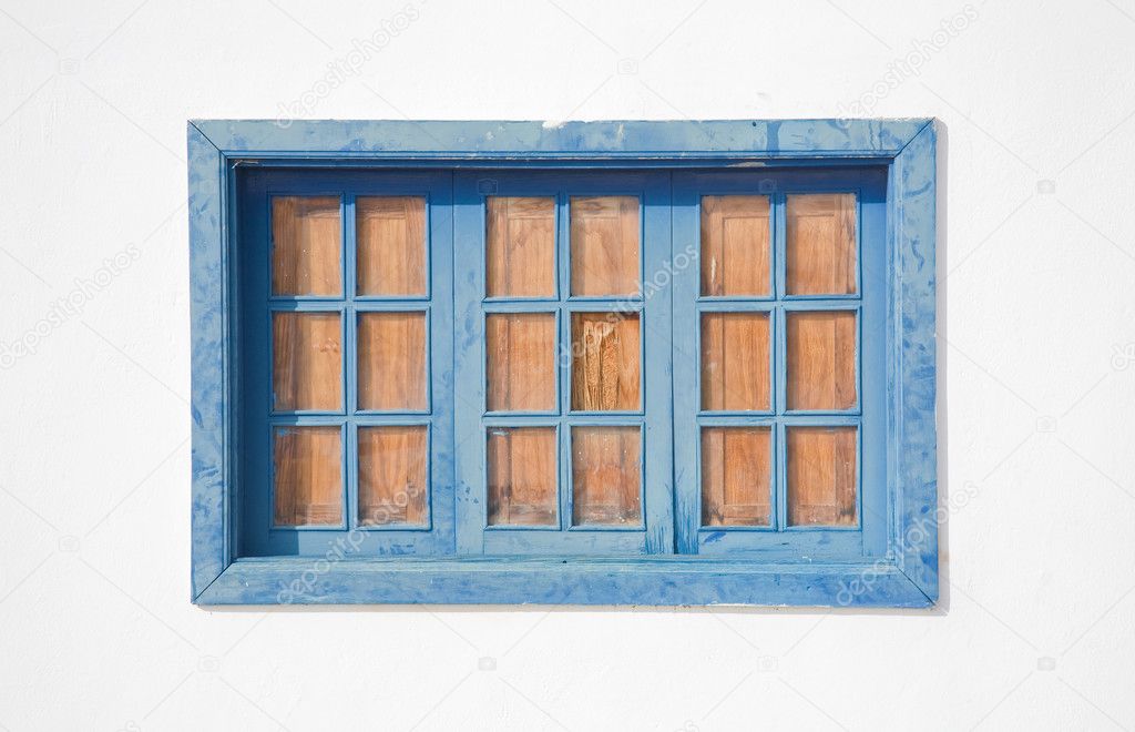 Architectural detail - faded blue window in a whitewashed wall; old spanish