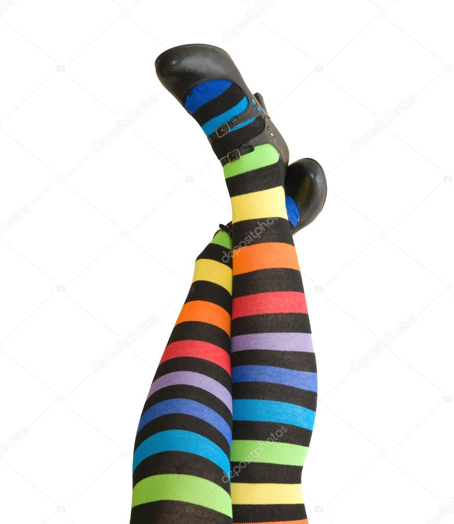 Female legs in stripy stockings and black shoes, isolated on white