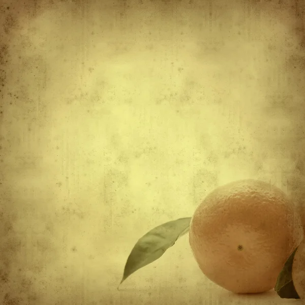 Getextureerde oud papier achtergrond met Mandarijn fruit — Stockfoto
